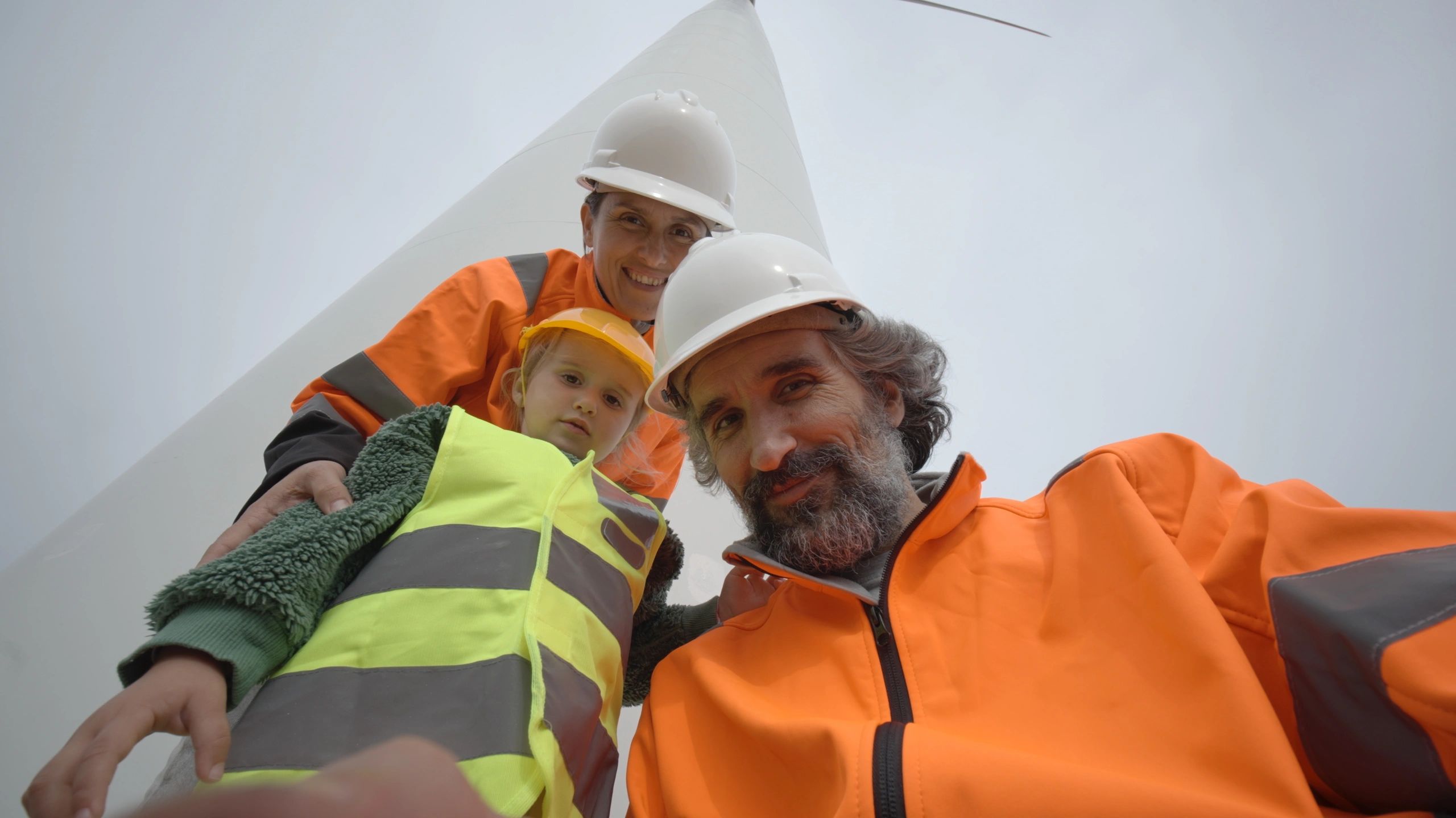 Engineers standing at a wind farm discussing work and safety planning