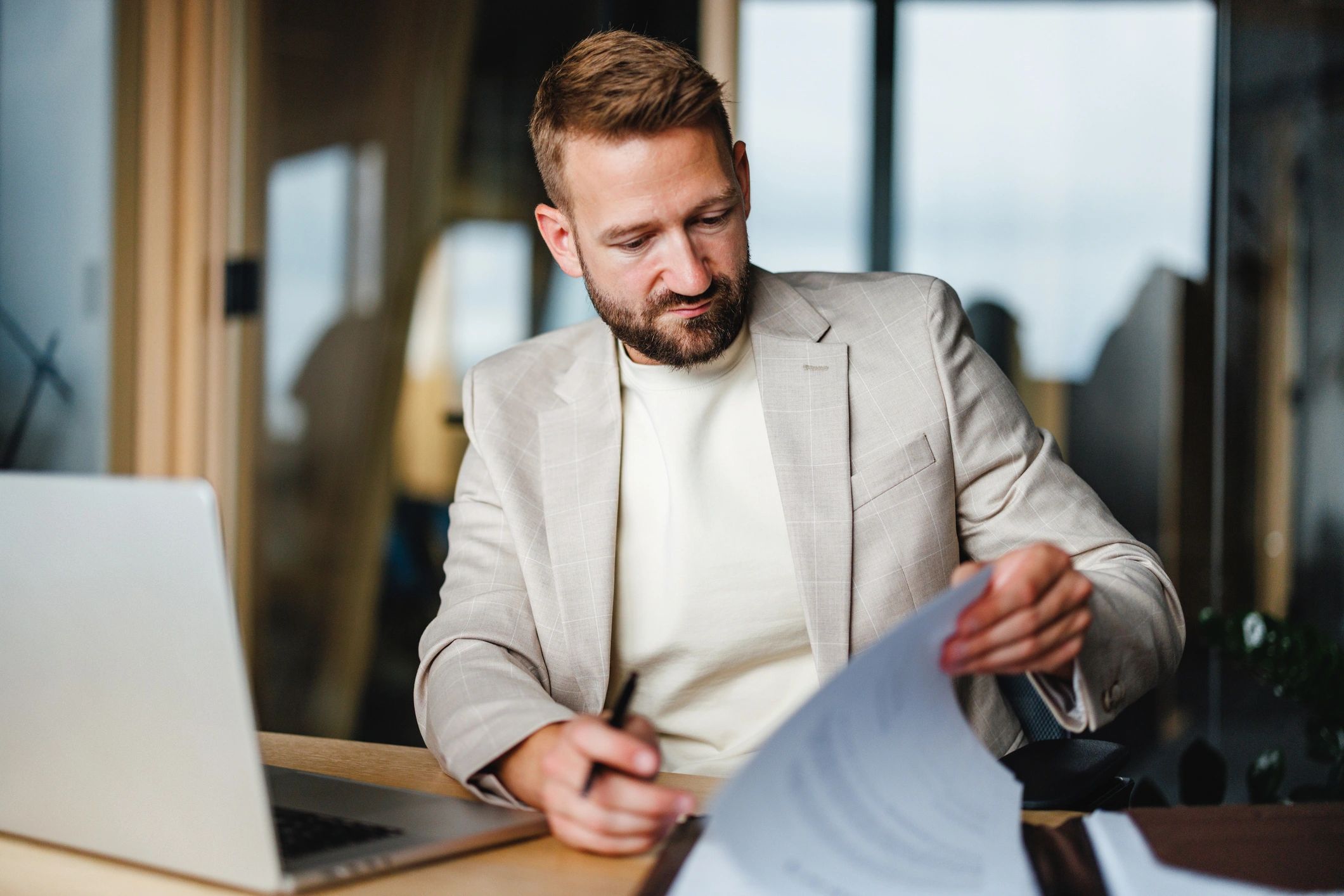 Consultant reviewing documents for emissions reporting